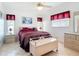 Bright bedroom with a ceiling fan, two windows and decorative furniture at 985 Everest Rd, Venice, FL 34293