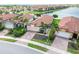 An aerial view highlighting the property's beautiful landscaping and serene lakeside setting at 10093 Cozy Grove Dr, Venice, FL 34293