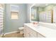 Well-lit bathroom features a single sink vanity, a window, and a shower/tub combination at 10093 Cozy Grove Dr, Venice, FL 34293
