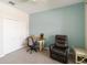 Relaxing bedroom with light-colored walls, a comfortable chair, and a ceiling fan for added comfort at 10093 Cozy Grove Dr, Venice, FL 34293