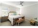 Relaxing bedroom with neutral tones, ceiling fan, side tables, and comfortable furniture at 10093 Cozy Grove Dr, Venice, FL 34293