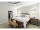 Bright bedroom with large bed, ceiling fan, bedside tables, and two windows for natural light at 10093 Cozy Grove Dr, Venice, FL 34293