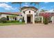 Inviting clubhouse entrance with lush landscaping, palm trees, and brick paved drive perfect for this community at 10093 Cozy Grove Dr, Venice, FL 34293