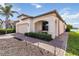 Exterior shot of a charming one story home featuring a brick driveway, covered porch and professional landscaping at 10093 Cozy Grove Dr, Venice, FL 34293