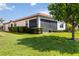 Lush lawn with mature landscaping complements the exterior of this beautiful home at 10093 Cozy Grove Dr, Venice, FL 34293