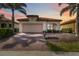Home exterior with brick driveway, manicured landscaping, a two-car garage, and neutral paint at 10093 Cozy Grove Dr, Venice, FL 34293