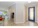 Inviting foyer with tile flooring, blue front door and an open view to the living area at 10093 Cozy Grove Dr, Venice, FL 34293