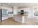 Modern kitchen with white cabinets, granite countertops, stainless steel appliances, and tile flooring at 10093 Cozy Grove Dr, Venice, FL 34293