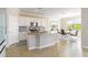 Bright kitchen with white cabinets, tile backsplash, granite countertops, and stainless steel appliances at 10093 Cozy Grove Dr, Venice, FL 34293
