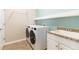 Efficient laundry room featuring modern washer and dryer, granite countertops, and ample storage space at 10093 Cozy Grove Dr, Venice, FL 34293