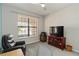 Cozy living room with a ceiling fan, large window and comfortable seating, perfect for relaxation and entertainment at 10093 Cozy Grove Dr, Venice, FL 34293