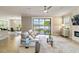 Bright living room showcasing tile floors, stylish furnishings, and beautiful views of the lake at 10093 Cozy Grove Dr, Venice, FL 34293