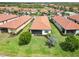 Aerial shot featuring home, manicured yard, screened lanai, and lush landscaping at 10093 Cozy Grove Dr, Venice, FL 34293