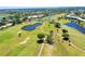 Aerial view of community golf course with multiple ponds and manicured greenery at 1018 Wexford Blvd # 1018, Venice, FL 34293