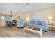 Inviting living room with blue sofa, dining area, and views of the kitchen at 1018 Wexford Blvd # 1018, Venice, FL 34293