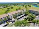 Aerial view showcasing the condo building near the golf course and picturesque ponds at 1018 Wexford Blvd # 1018, Venice, FL 34293