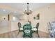 Formal dining area with chandelier, hardwood floors, and an open view of the kitchen at 1018 Wexford Blvd # 1018, Venice, FL 34293
