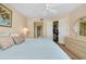 Comfortable bedroom with a ceiling fan, closet and dresser storage space, and an ensuite bathroom at 1018 Wexford Blvd # 1018, Venice, FL 34293