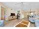 Modern living room with a TV, desk, dining area, and light wood floors at 1018 Wexford Blvd # 1018, Venice, FL 34293