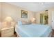 Inviting bedroom featuring coastal decor, a ceiling fan, and an ensuite bathroom for added convenience at 1018 Wexford Blvd # 1018, Venice, FL 34293