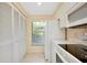 Clean, white kitchen with pantry storage, and a window provides natural lighting at 1018 Wexford Blvd # 1018, Venice, FL 34293