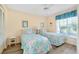 Bright guest bedroom with two twin beds and a window at 1018 Wexford Blvd # 1018, Venice, FL 34293