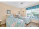 Cozy bedroom featuring two twin beds and a view from the window at 1018 Wexford Blvd # 1018, Venice, FL 34293