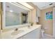 Well-lit bathroom features double sinks, a washer/dryer unit, a shower with glass door, and storage at 1018 Wexford Blvd # 1018, Venice, FL 34293