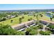 Condo building showcasing proximity to the golf course and mature trees at 1018 Wexford Blvd # 1018, Venice, FL 34293