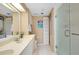 Bathroom features double sinks, a glass shower door, and modern fixtures at 1018 Wexford Blvd # 1018, Venice, FL 34293