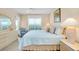 Comfortable bedroom with a queen size bed, light wood floors, and a cozy armchair at 1018 Wexford Blvd # 1018, Venice, FL 34293