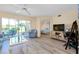 Bright living room with modern furniture, wood floors, and sliding glass doors to the lanai at 1018 Wexford Blvd # 1018, Venice, FL 34293