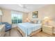 Inviting bedroom with a queen size bed, a large window, and stylish lamps at 1018 Wexford Blvd # 1018, Venice, FL 34293
