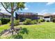 Beautiful backyard with screened in patio, mature tree and manicured landscaping at 10618 Corkwood Ct, Venice, FL 34293