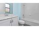 Modern bathroom with white vanity and marble countertop, plus a tub/shower combination at 10618 Corkwood Ct, Venice, FL 34293