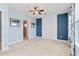 Bedroom with blue walls, white trim, and white accent wall with views of an ensuite bathroom at 10618 Corkwood Ct, Venice, FL 34293