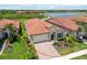 Beautiful home with tile roof, attached garage, brick driveway, and lovely landscaping in quiet neighborhood at 10618 Corkwood Ct, Venice, FL 34293