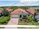 Charming single-story home with a tile roof, brick driveway, and lush front yard in a peaceful neighborhood at 10618 Corkwood Ct, Venice, FL 34293
