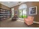 Cozy library with ample seating, large window, and bookshelves for a relaxing atmosphere at 10618 Corkwood Ct, Venice, FL 34293
