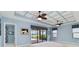 Bright living space with screened in patio access, coffered ceilings, and contemporary interior design at 10618 Corkwood Ct, Venice, FL 34293