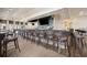 A modern bar with ample seating, a large TV screen, and a fully stocked selection of beverages at 10618 Corkwood Ct, Venice, FL 34293