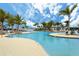 Resort-style community pool with plenty of lounge seating and palm trees at 10618 Corkwood Ct, Venice, FL 34293
