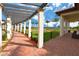 Covered walkway with lush landscaping, offering a serene pathway through the community at 10618 Corkwood Ct, Venice, FL 34293
