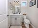 Well-lit powder room with a modern vanity, decorative accents, and clean lines, offering a convenient space at 10973 Trevino St, Englewood, FL 34223