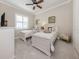 Charming bedroom featuring twin beds, decorative accents, and neutral tones, creating a cozy and inviting atmosphere at 10973 Trevino St, Englewood, FL 34223