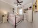Charming bedroom featuring a metal bed frame, soft pink accents, a dresser, and a window with natural light at 10973 Trevino St, Englewood, FL 34223