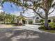 Elegant clubhouse exterior featuring manicured landscaping, a circular driveway, and classic architectural details at 10973 Trevino St, Englewood, FL 34223