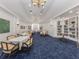 Elegant dining room with refined decor, built-in bookshelves, and ample seating at 10973 Trevino St, Englewood, FL 34223