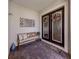 Covered porch featuring double doors, a bench, and decor at 10973 Trevino St, Englewood, FL 34223