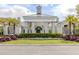 Attractive building exterior with lush landscaping and mature palm trees at 10973 Trevino St, Englewood, FL 34223